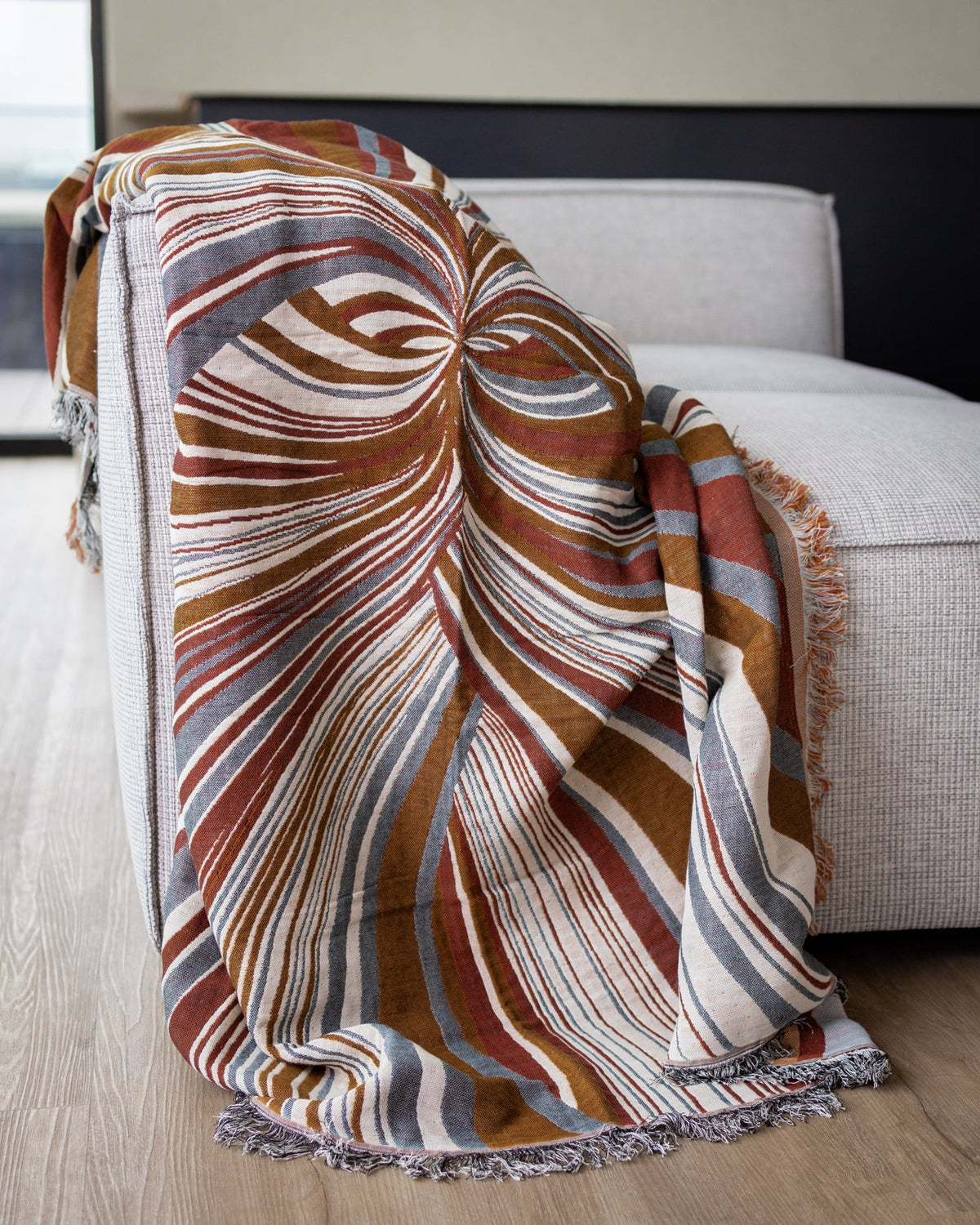 Stevie organic cotton tapestry throw blanket showing a layered color palette