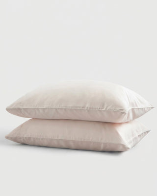 Two ecru pillows stacked on a white background