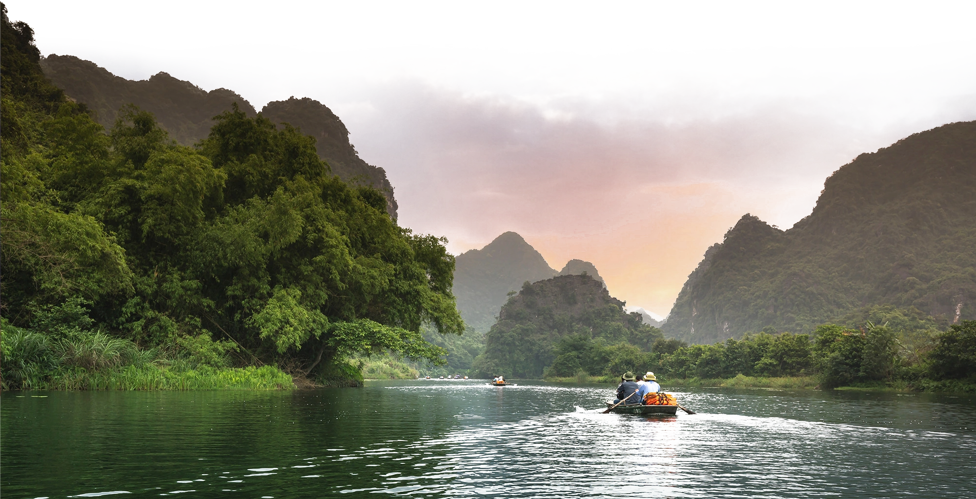 River winding through a lush rainforest at sunset